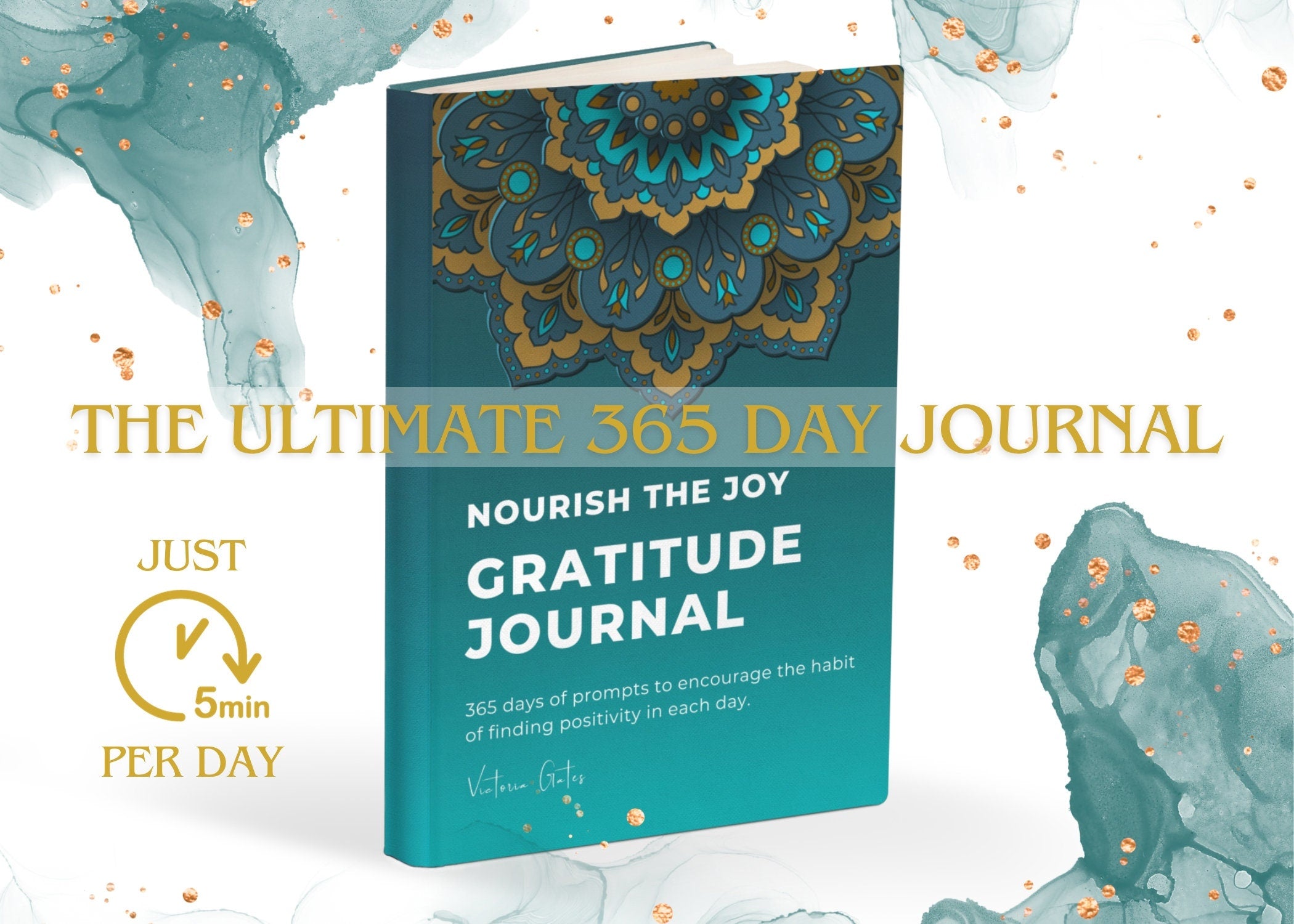 May include: A teal blue book with a gold mandala design on the front cover. The title of the book is 'The Ultimate 365 Day Journal Nourish The Joy Gratitude Journal.' The subtitle is '365 days of prompts to encourage the habit of finding positivity in each day.' The author's name is 'Victoria Gotte.' The book is displayed against a white background with teal blue and gold watercolor splatters.